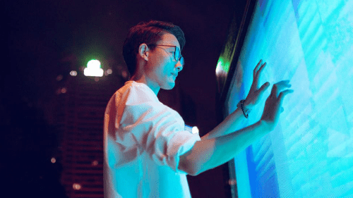 Person interacting with a digital board.