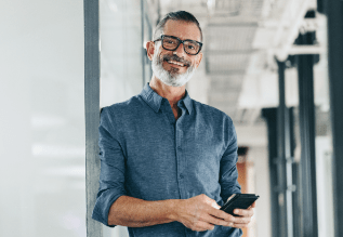 A person standing holding a mobile device.