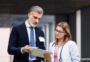 Two people looking at a file together.