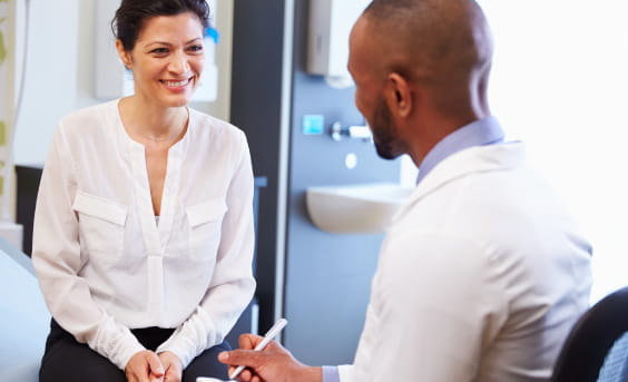 Clinical trial participant with healthcare provider in discussion.