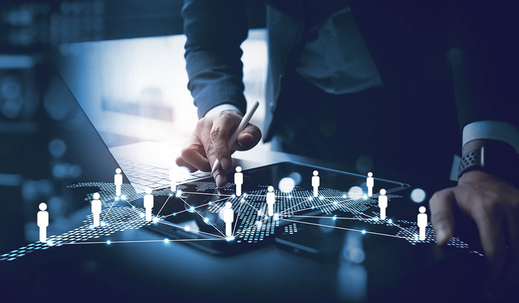 A professional interacts with a digital tablet, surrounded by floating network icons representing people and connections.