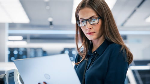 Pharmaceutical professional accessing C+D on a laptop device.
