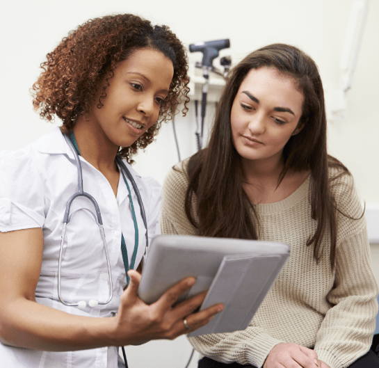 Healthcare professional guiding a patient through their trial journey with digital content and experiences through Citeline Connect.
