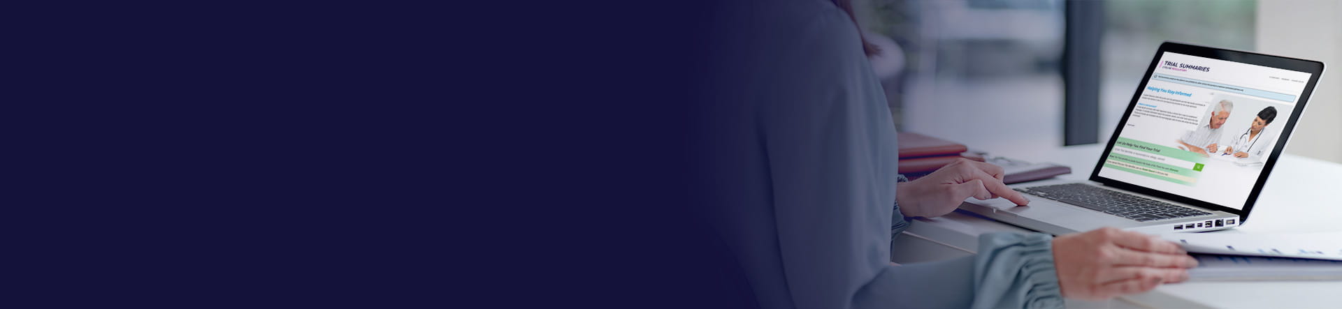 A clinical trial sponsor using a laptop to access TrialSummaries.com.