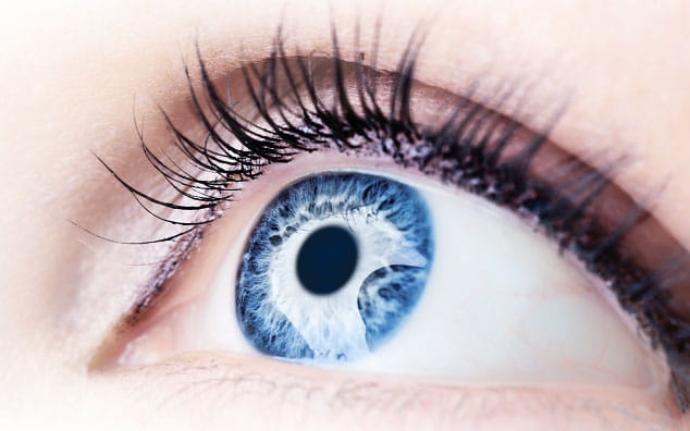 Woman's eye with vivid blue iris, detailed close up.