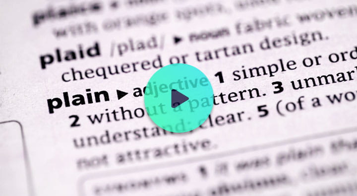A close-up of a dictionary page displaying definitions for the word plain.