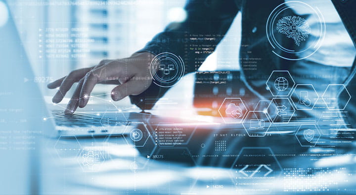 Close-up of a person typing on a laptop, overlaid with digital data and technology icons.